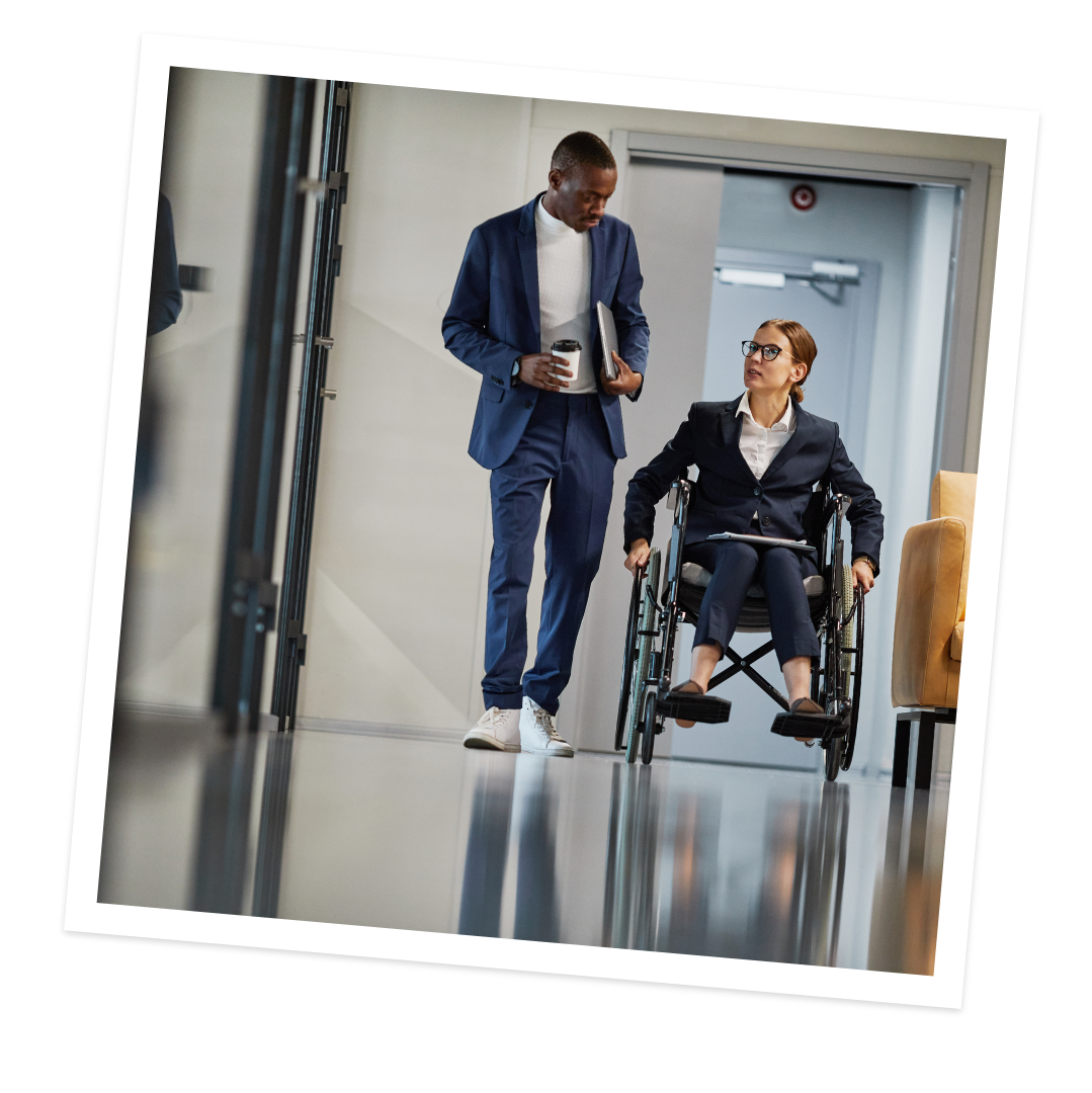Business woman in a wheelchair with a colleague